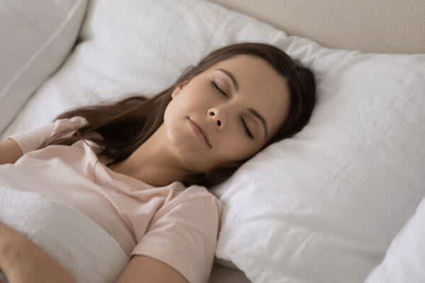 Sleep FAQs stock photo of a woman in deep sleep