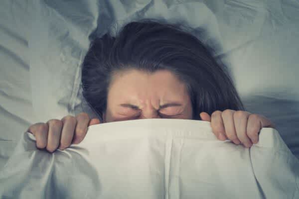 The Relationship Between Dreams and Mental Health Woman having a bad dream