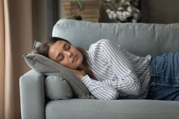 How Long Should You Nap? stock photo of a woman taking a nap on a couch