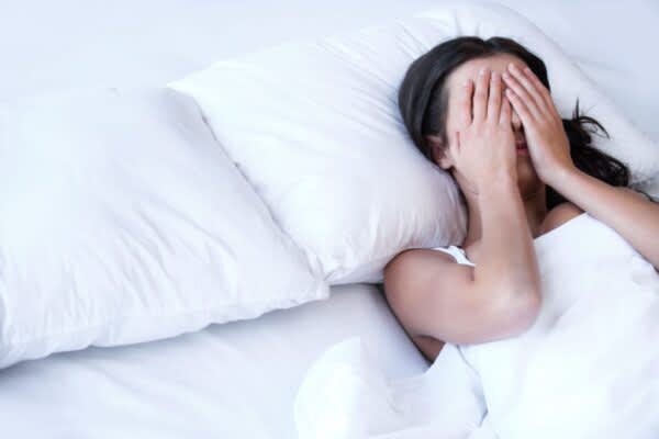 Parasomnias: An Overview woman with her hands over her eyes